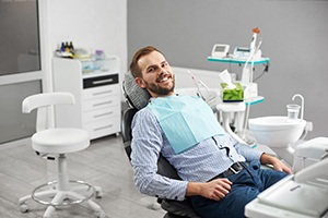 Male patient reclining in chair, ready for periodontal disease treatment