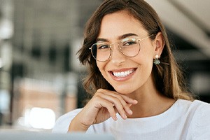 Close-up of a woman with glasses smiling