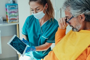 older patient talking to dentist  