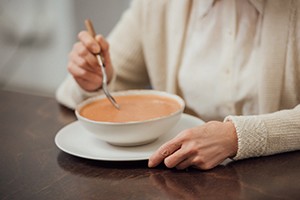 Person eating soup in Worcester