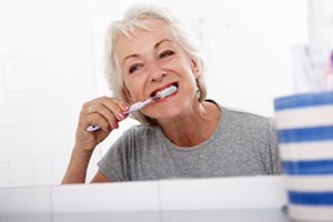Woman brushing teeth in Worcester