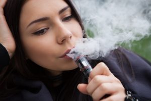 Young woman vaping