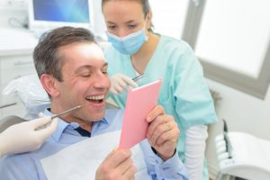 man smiling into mirror