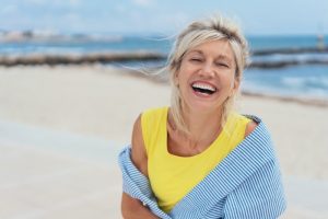 an older woman on the beach smiling