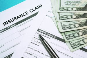 an image of money and insurance claims paperwork