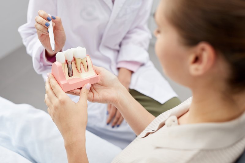 a dentist explaining why smoking is not a good idea while wearing dental implants