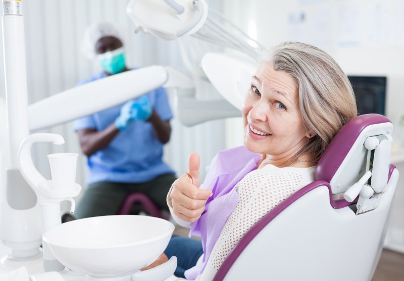 woman giving thumbs up after a bone graft in Worcester