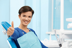 Female patient at periodontist’s office giving thumbs up