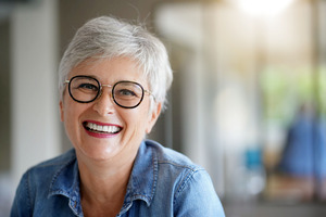 Senior woman in denim jacket smiling