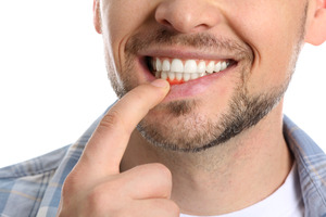 Pulling down lip to show inflamed gums